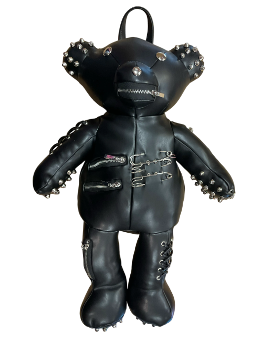 A black faux-leather teddy bear backpack styled with silver studs, zippers, and metal hardware, shown against a plain white background.