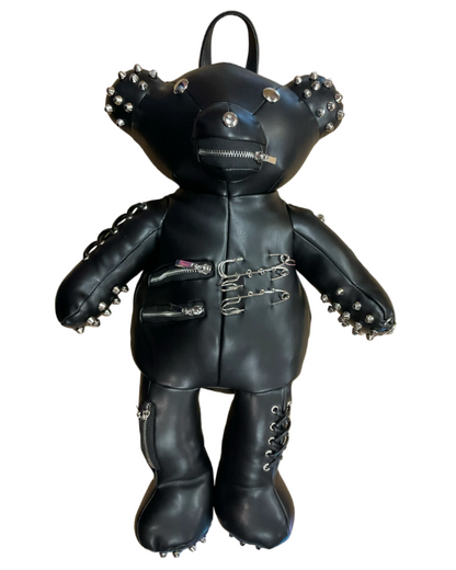 A black faux-leather teddy bear backpack styled with silver studs, zippers, and metal hardware, shown against a plain white background.