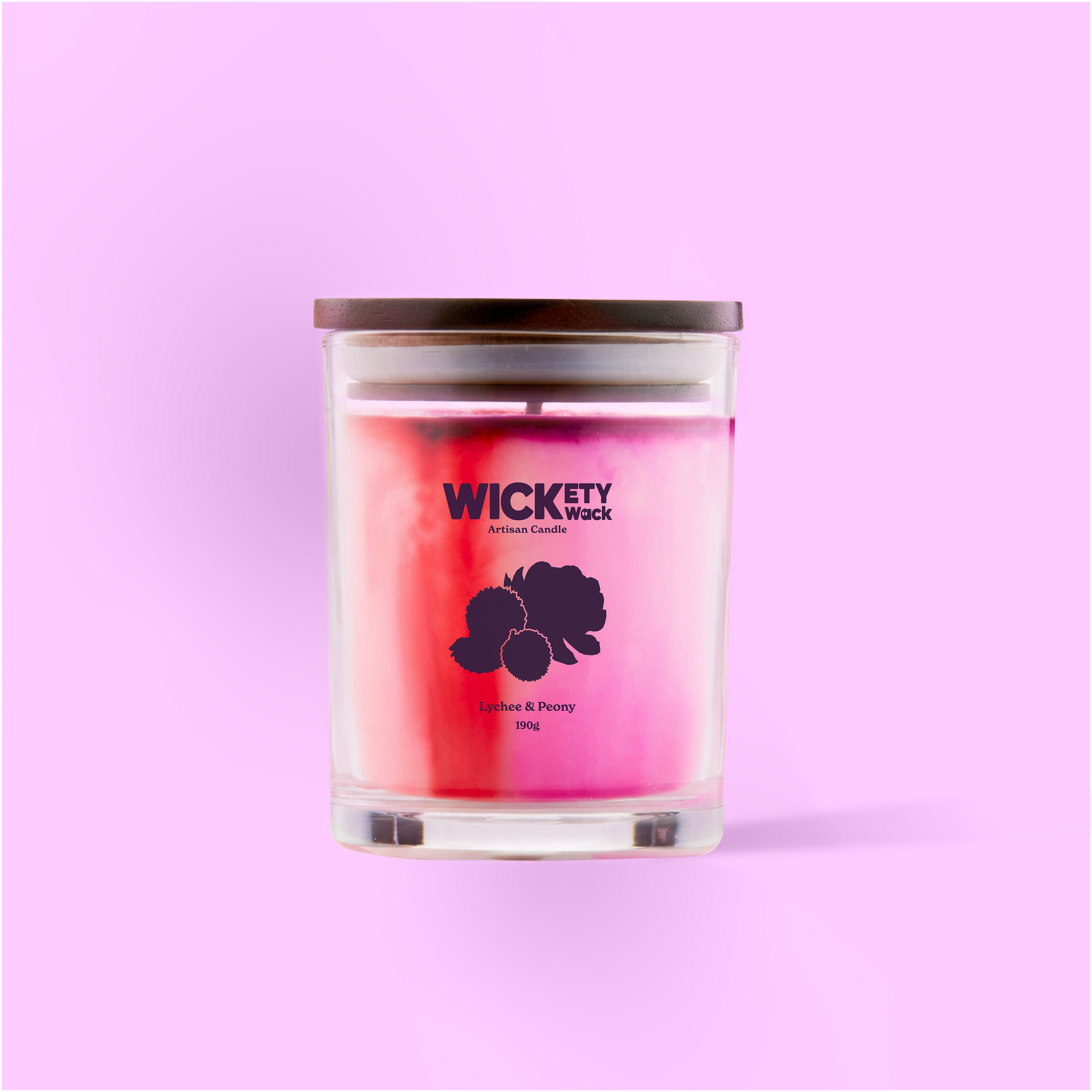 Candle with 'Wickety Wick' branding on a pink background